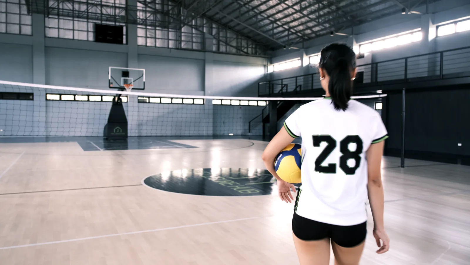 Volleyball player standing on The Leisure Hub indoor court